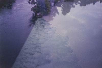 High angle view of trees by lake against sky