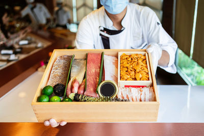 Midsection of man preparing food in restaurant