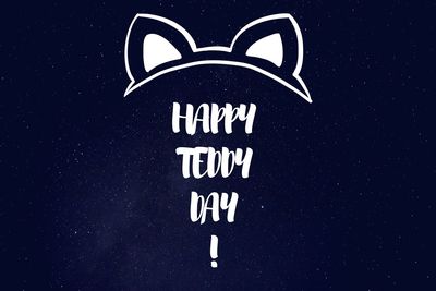 Close-up of information sign against black background