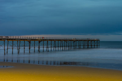 Pier over sea against sky