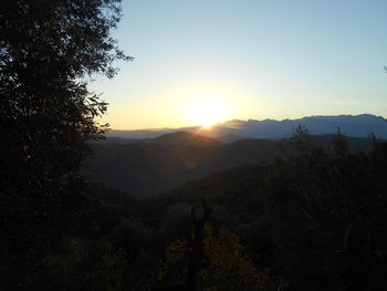 Scenic view of mountains against sky at sunset