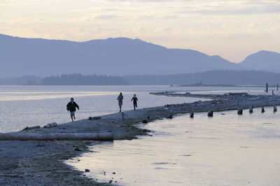 People on beach against sky