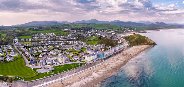 High angle view of buildings by sea against sky