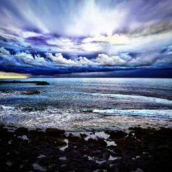 Scenic view of sea against cloudy sky