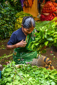 Midsection of woman holding fresh plants