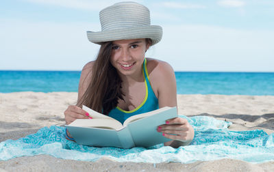 Portrait of smiling young woman on beach