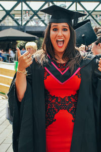 Portrait of smiling young woman standing outdoors