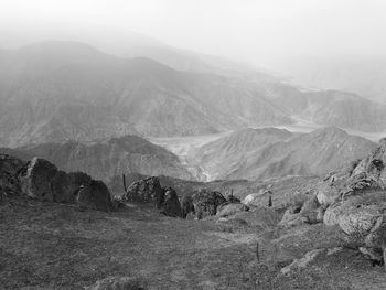 View of rocky mountains in foggy weather