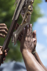 Close-up of hand holding cross
