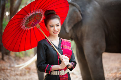 Portrait of smiling young woman standing outdoors