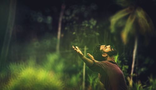 Man feeding on tree in forest