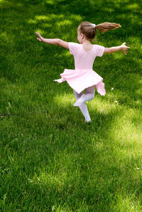 Little girl in ballet costume, dancing outdoors