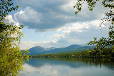 Scenic view of lake and mountains against sky