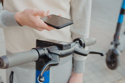 Midsection of man using mobile phone