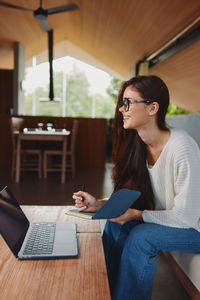 Young woman using laptop at home