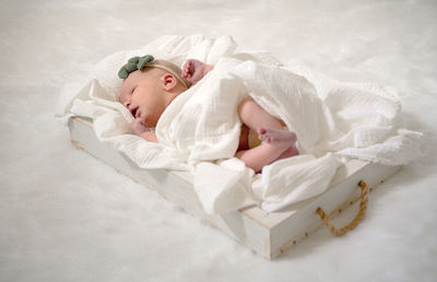 High angle view of woman lying on bed