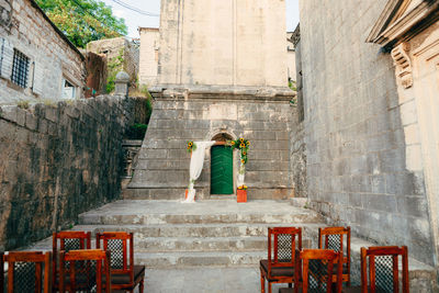 Rear view of woman standing by staircase outside building