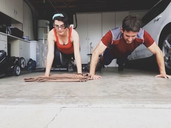 Young couple exercising in garage