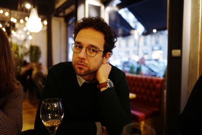 Close-up of man sitting in illuminated room