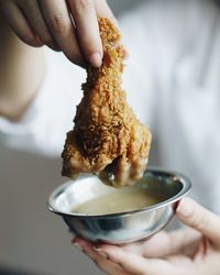 Cropped image of woman holding food