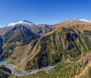 Scenic view of mountains against clear blue sky