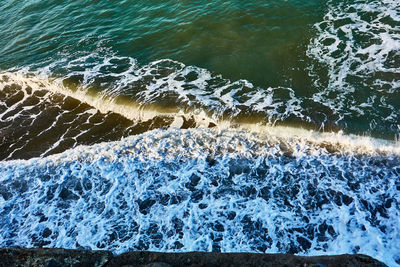 High angle view of waves splashing on shore