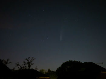 Low angle view of silhouette trees against sky at night
