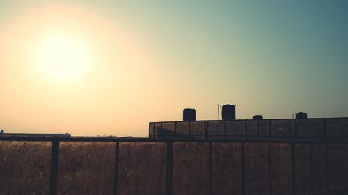 Built structures against clear sky at sunset