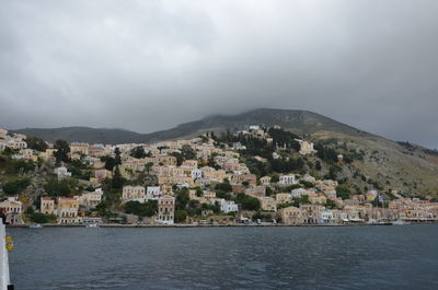 Town by sea against sky in city