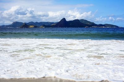 Scenic view of sea against cloudy sky