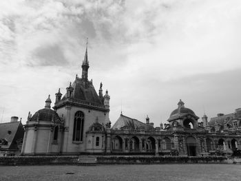 Low angle view of cathedral against cloudy sky