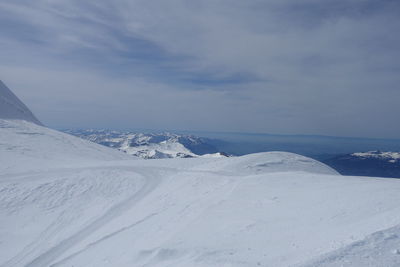 Scenic view of snow covered mountains against sky