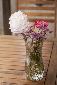 Close-up of rose in glass vase on table
