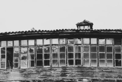 Exterior of building by sea against clear sky