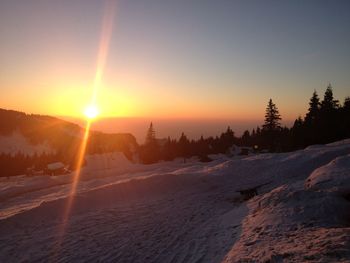 Scenic view of snow against sky during sunset