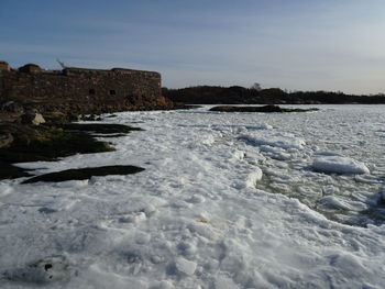 Scenic view of frozen lake against sky