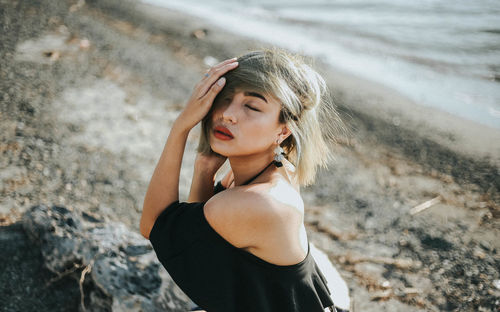 Portrait of beautiful young woman standing outdoors