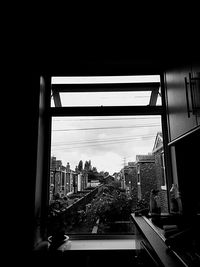 View of bridge in city against sky