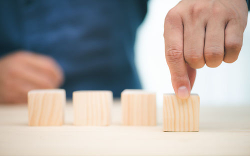 Close-up of person holding hands on table