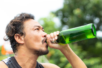Close-up of man drinking beer 