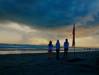 Scenic view of beach against cloudy sky