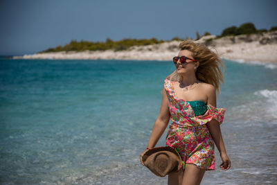 Young woman wearing sunglasses on beach