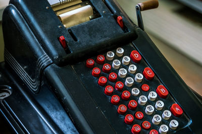A outdated calculator from yesteryear - a close-up view of the keypad and handle