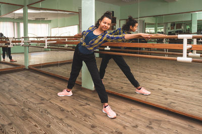 Full length of woman dancing on floor
