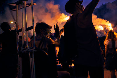 Silhouette people against sky at sunset