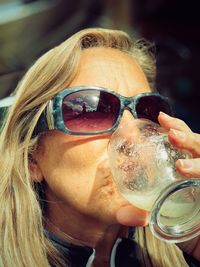 Close-up of mature woman having drink