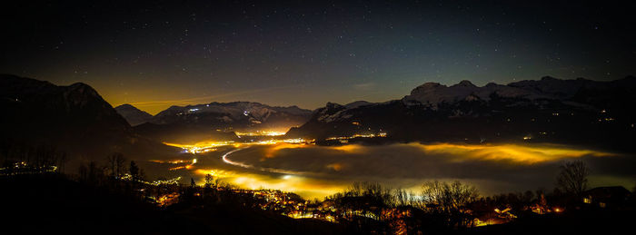 Scenic view of silhouette mountains against sky at night