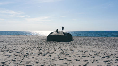 People on beach against sky