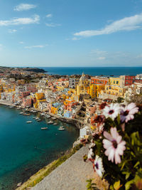 High angle view of townscape by sea against sky