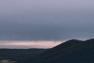 Scenic view of mountains against sky at sunset